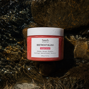 Saach Sugar Body Scrub in a jar, showing textured sugar exfoliant with a natural, creamy appearance for smooth skin.