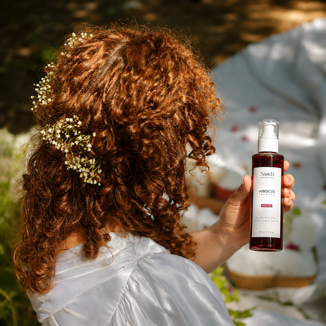 Saach Hibiscus Infused Hair Oil bottle with hibiscus flowers and herbal ingredients on a white background