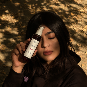 Saach Hibiscus Infused Hair Oil bottle with flowers and herbs, showcasing natural ingredients and rich, nourishing formula.